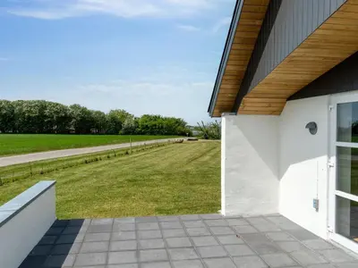 a view of a field from the side of a building at Holiday Home Imilie - 250m to the fjord by Interhome in Redsted