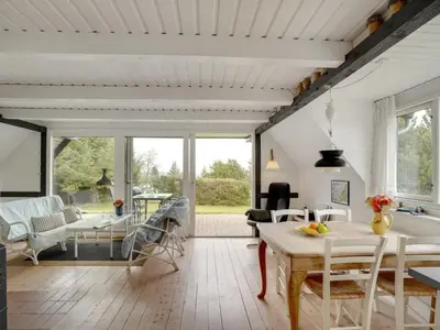 a kitchen and living room with a table and chairs at Holiday Home Brunhild - 300m to the fjord by Interhome in Fur