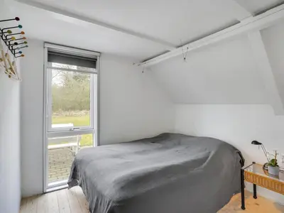 a bedroom with a bed and a window at Holiday Home Brunhild - 300m to the fjord by Interhome in Fur