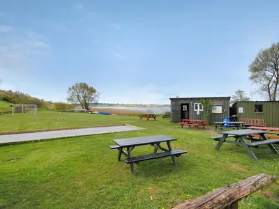 a group of picnic tables in a field at Holiday Home Imgert - 300m to the fjord by Interhome in Løgstrup