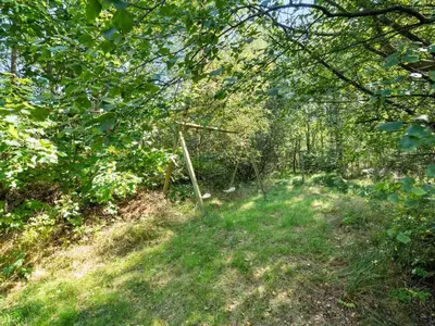 a fence in the middle of a forest at Holiday Home Jussi - 3-5km from the sea by Interhome in Brovst