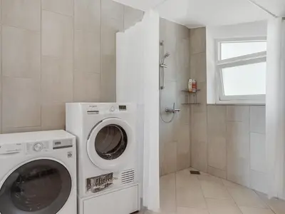 a laundry room with a washer and dryer at Holiday Home Ullvi - 3-8km from the sea by Interhome in Brovst