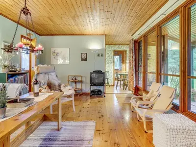 a living room with a wooden ceiling at Holiday Home Carina - 5km from the sea by Interhome in Brovst