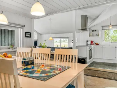 a kitchen and dining room with a table and chairs at Holiday Home Eske - 200m to the fjord by Interhome in Åbybro