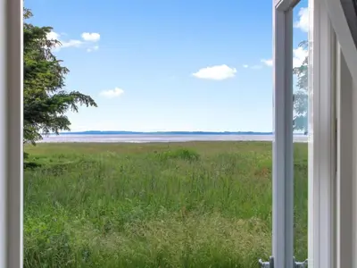 a view of a field from a window at Holiday Home Eske - 200m to the fjord by Interhome in Åbybro