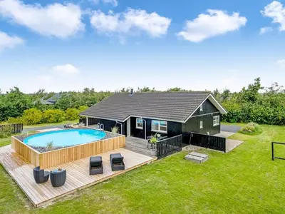 a house with a swimming pool and a deck at Holiday Home Asel - 4km from the sea by Interhome in Brovst