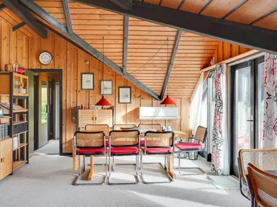 a dining room with a table and chairs at Holiday Home Tenho - 4-4km from the sea by Interhome in Brovst