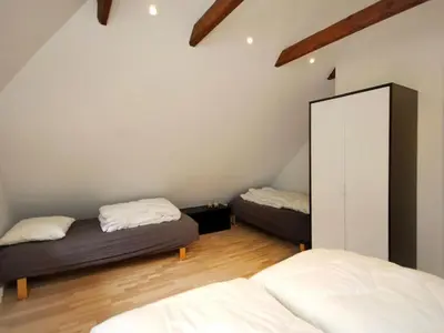 a bedroom with two beds and a mirror at Holiday Home Rigitte - 1-5km from the sea by Interhome in Pandrup