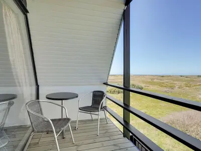 two chairs and a table on a porch with a view at Holiday Home Viona - 350m from the sea by Interhome in Pandrup