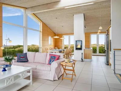 a living room with a couch and a table at Holiday Home Tinea - 50m from the sea by Interhome in Pandrup