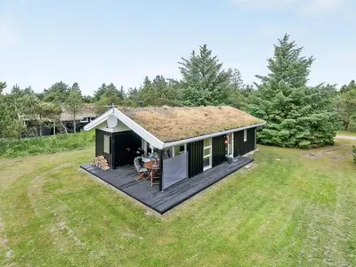 a small house with a deck in the yard at Holiday Home Svantepolk - 1-1km from the sea by Interhome in Pandrup