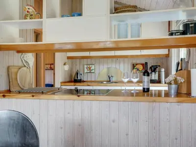 a kitchen with two wine glasses on a counter at Holiday Home Svantepolk - 1-1km from the sea by Interhome in Pandrup