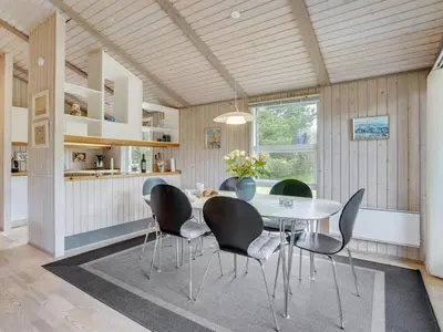 a dining room with a table and chairs at Holiday Home Svantepolk - 1-1km from the sea by Interhome in Pandrup