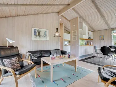 a living room with a couch and a table at Holiday Home Svantepolk - 1-1km from the sea by Interhome in Pandrup