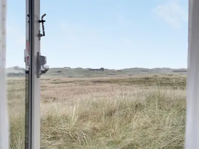 an open window with a view of a field at Holiday Home Eri - 300m from the sea by Interhome in Pandrup