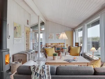 a living room with a couch and a table at Holiday Home Eri - 300m from the sea by Interhome in Pandrup