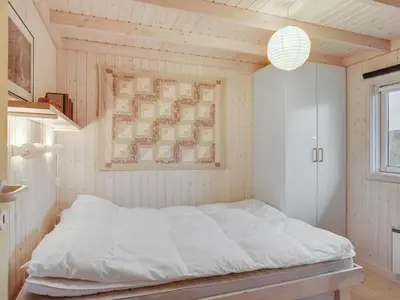 a bedroom with a white bed in a room at Holiday Home Eri - 300m from the sea by Interhome in Pandrup