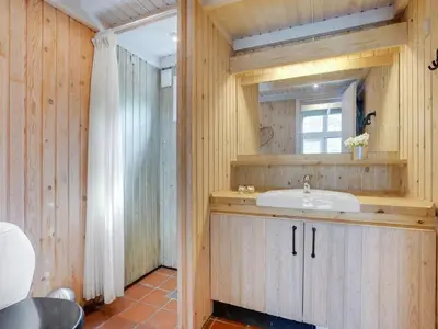 a bathroom with a sink and a window at Holiday Home Evan - 1-3km from the sea by Interhome in Pandrup
