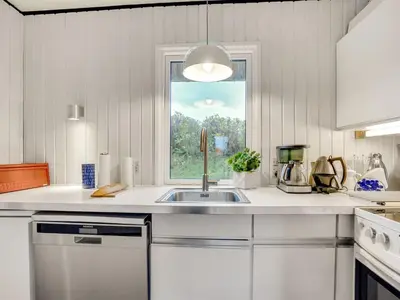 a kitchen with a sink and a window at Holiday Home Emiline - 250m from the sea by Interhome in Saltum