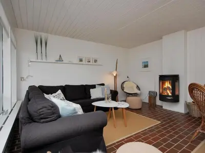 a living room with a couch and a fireplace at Holiday Home Frieda - 7-2km from the sea by Interhome in Pandrup