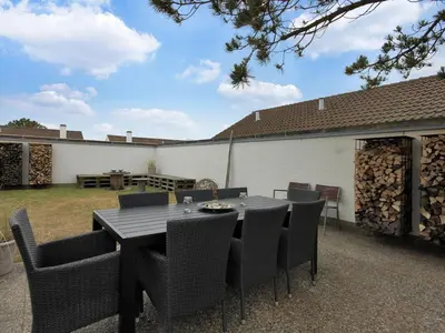 a black table and chairs on a patio at Holiday Home Frieda - 7-2km from the sea by Interhome in Pandrup