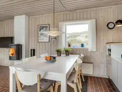 a kitchen with a white dining room table and chairs at Holiday Home Emiljan - 400m from the sea by Interhome in Pandrup