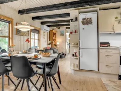 a kitchen and dining room with a white refrigerator at Holiday Home Marite - 200m from the sea by Interhome in Pandrup
