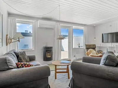 a living room with two couches and a table at Holiday Home Ingomar - 300m from the sea by Interhome in Pandrup