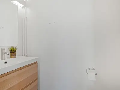 a white bathroom with a sink and a shower at Holiday Home Ingomar - 300m from the sea by Interhome in Pandrup