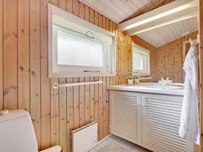 a bathroom with a sink and a toilet at Holiday Home Editt - 2km from the sea by Interhome in Pandrup
