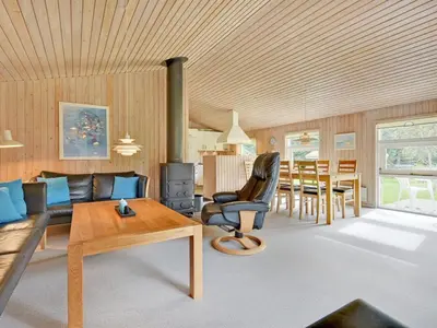 a living room with a couch and a table at Holiday Home Editt - 2km from the sea by Interhome in Pandrup