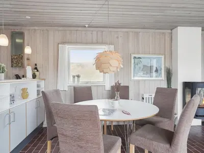 a dining room with a white table and chairs at Holiday Home Viena - 400m from the sea by Interhome in Pandrup