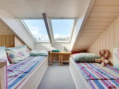 two beds in a room with two windows at Holiday Home Krister - 250m to the fjord by Interhome in Farsø