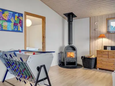 a living room with a wood stove in a room at Holiday Home Awenita - 50m to the fjord by Interhome in Løgsted