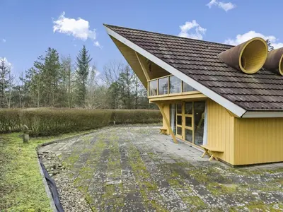 a yellow house with a pitched roof and a driveway at Holiday Home Tally - 800m to the fjord by Interhome in Løgsted