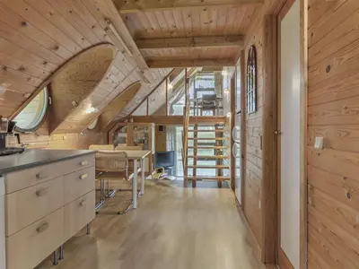 a kitchen and dining room with a wooden ceiling at Holiday Home Tally - 800m to the fjord by Interhome in Løgsted