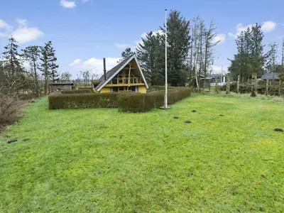 a house in the middle of a grassy field at Holiday Home Tally - 800m to the fjord by Interhome in Løgsted