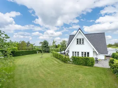 a white house with a large yard at Holiday Home Tamer - 500m to the fjord by Interhome in Farsø