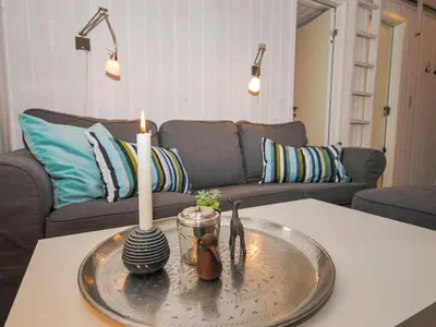 a living room with a table with a candle on it at Holiday Home Evelina - 150m to the fjord by Interhome in Løgsted