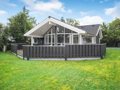 a house with a fence in a yard at Holiday Home Evelina - 150m to the fjord by Interhome in Løgsted