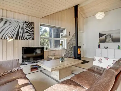 a living room with a couch and a tv at Holiday Home Anethe - 100m to the fjord by Interhome in Løgstør
