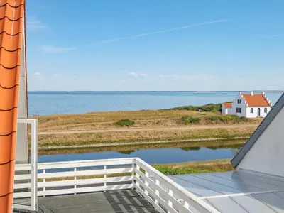 a view of the ocean from the balcony of a house at Holiday Home Yorrick - 50m to the fjord by Interhome in Løgstør