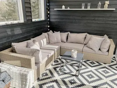 a patio with a couch and a table at Holiday Home Eireen - 600m to the fjord by Interhome in Farsø