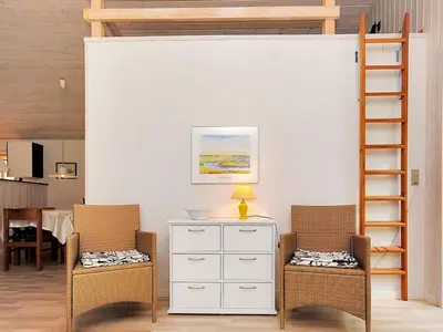 a living room with two chairs and a white dresser at Holiday Home Gesina - 600m to the fjord by Interhome in Løgstør