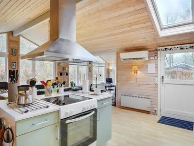 a kitchen with a stove top oven in a room at Holiday Home Magh by Interhome in Års