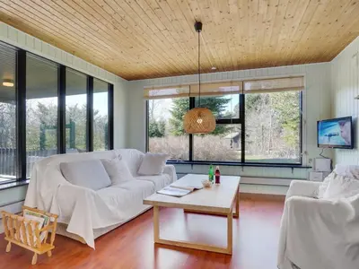 a living room with a white couch and a table at Holiday Home Ludde - 500m to the fjord by Interhome in Løgstør