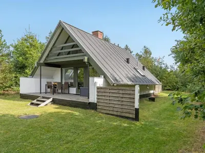 a small house with a roof on a yard at Holiday Home Valo - 400m to the fjord by Interhome in Løgsted
