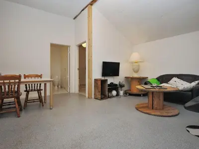 a living room with a couch and a table at Holiday Home Millie - 3km to the fjord by Interhome in Løgstør
