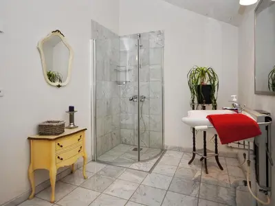 a bathroom with a shower and a sink and a mirror at Holiday Home Millie - 3km to the fjord by Interhome in Løgstør