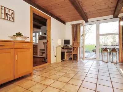 a kitchen with a table and a desk with a computer at Holiday Home Millie - 3km to the fjord by Interhome in Løgstør